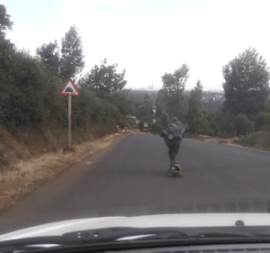 steep road sign + skater